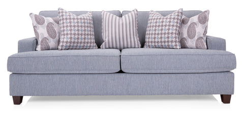 grey sofa with patterned pillows on it